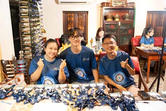 Students making heart signs at a workshop